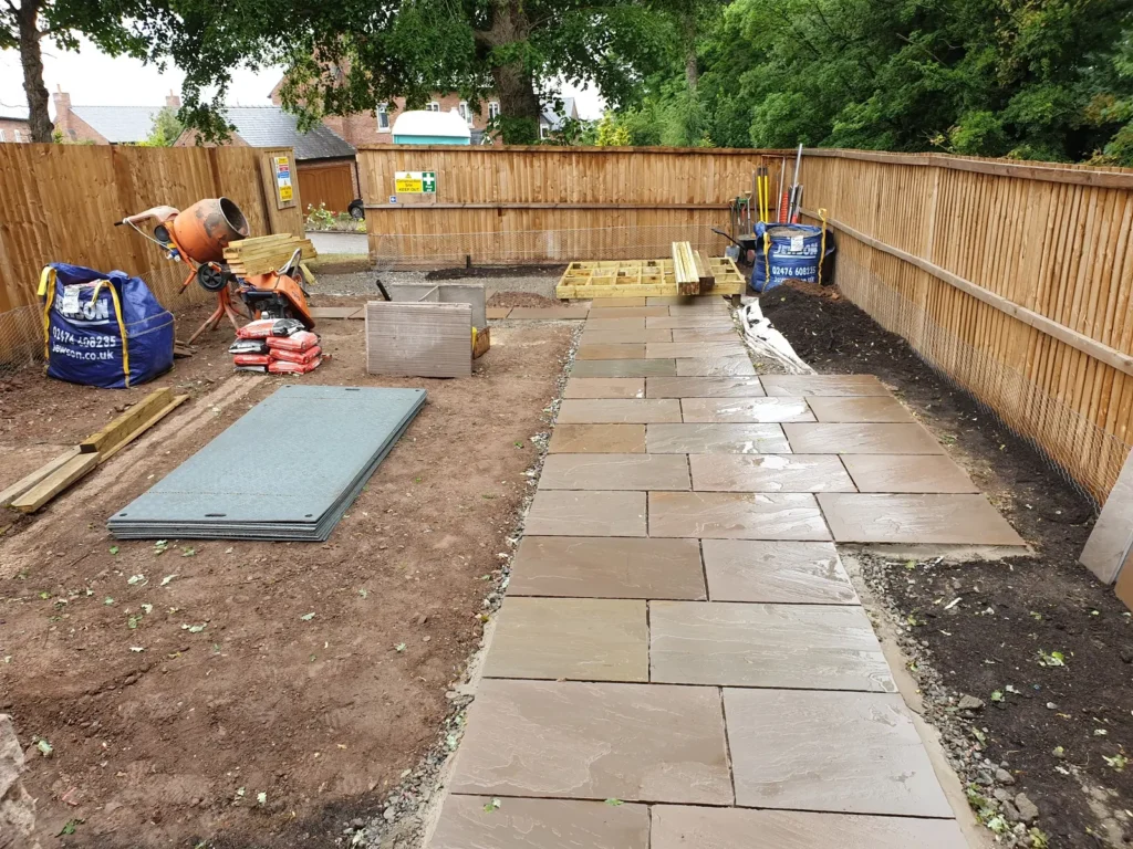Clean and organised landscaping site during paving installation in Malpas courtyard garden