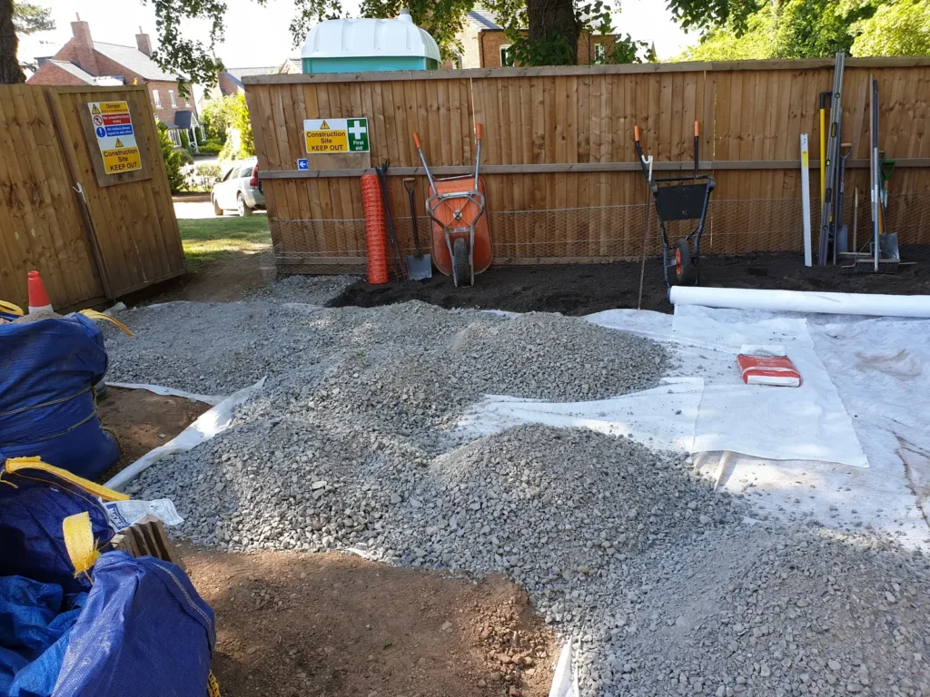 Geotextile membrane and subbase material prepared for courtyard garden paving