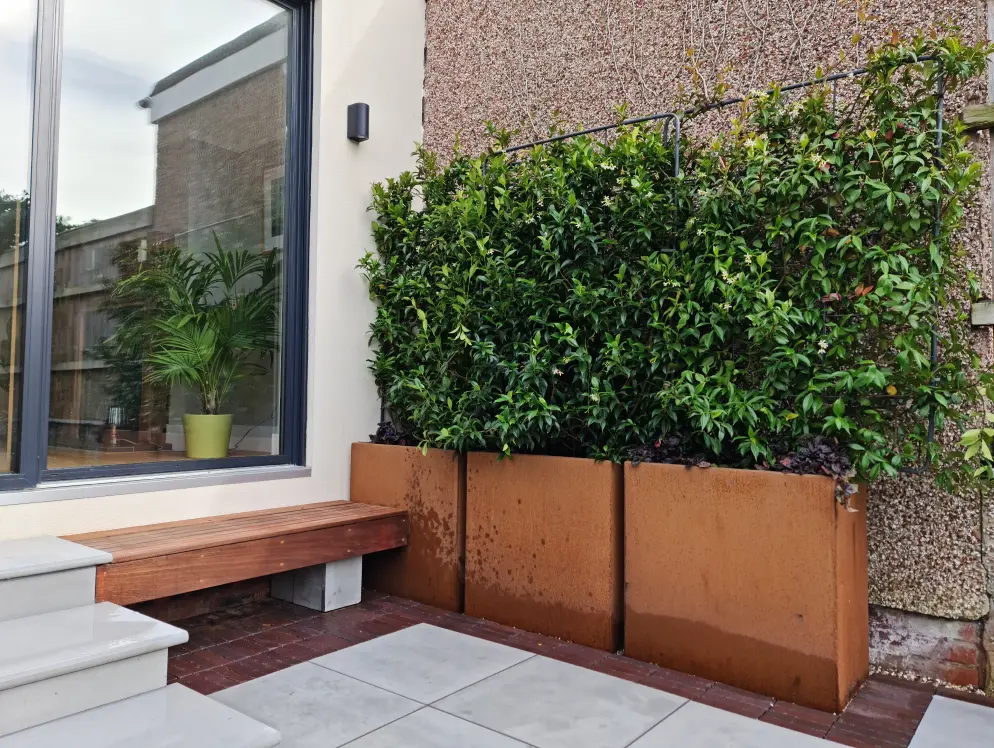 Corten planters and timber bench in the Nordic Soul courtyard garden in Allerton