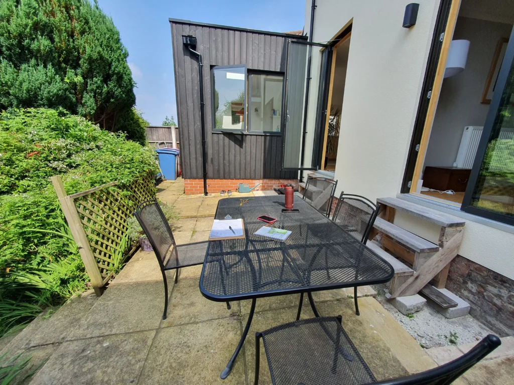 Original cramped terrace and temporary wooden steps before the Allerton garden makeover