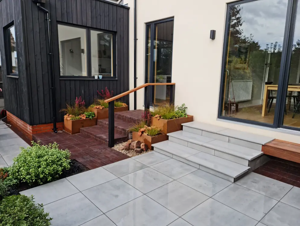 Finished Allerton courtyard garden with clay paver steps, corten planters and modern paving