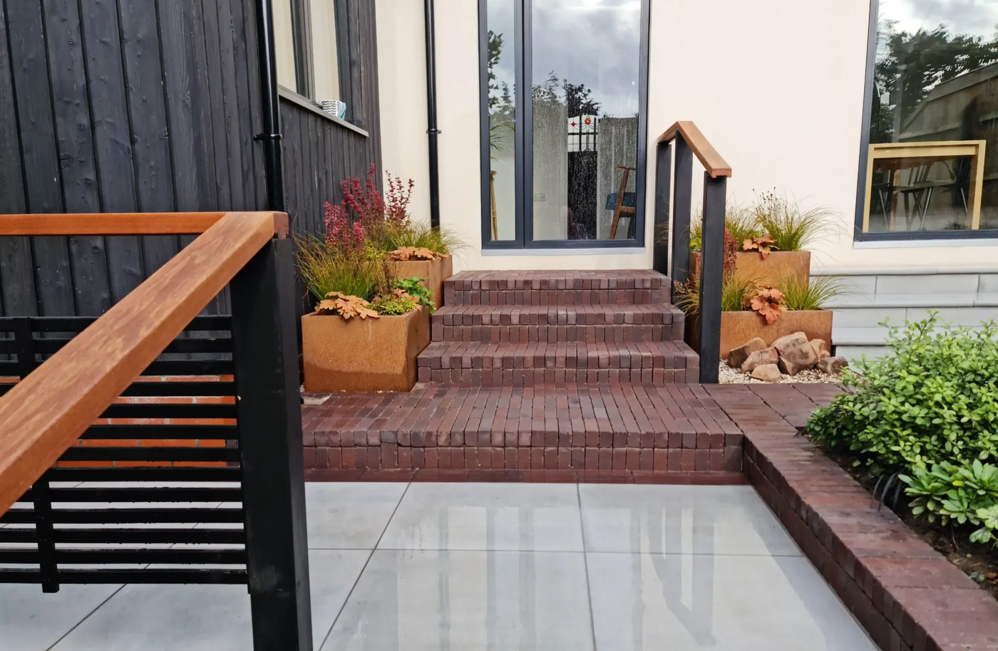Clay paver garden steps with corten steel planters and planting in Nordic Soul Allerton