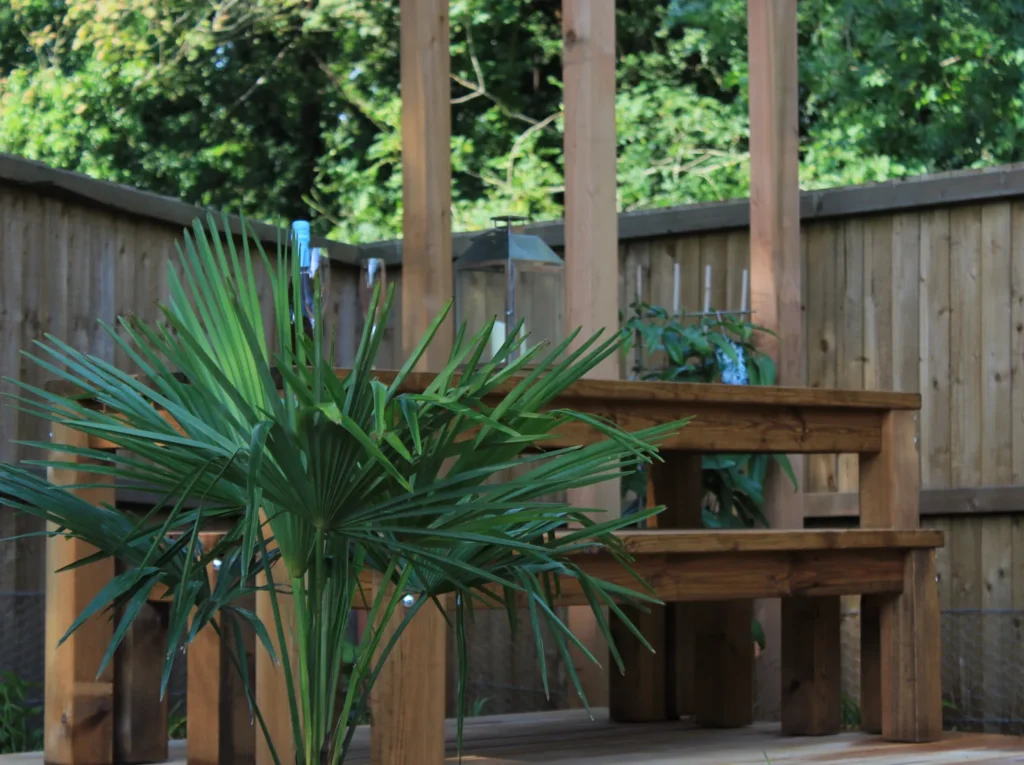 Timber pergola seating area surrounded by planting in a landscaped courtyard garden