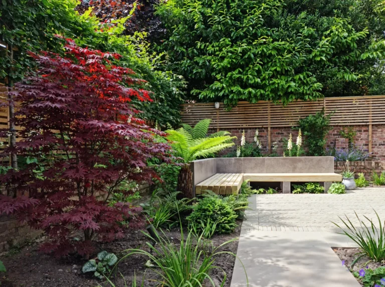 Soft natural garden planting with timber bench seating in Victorian Altrincham property