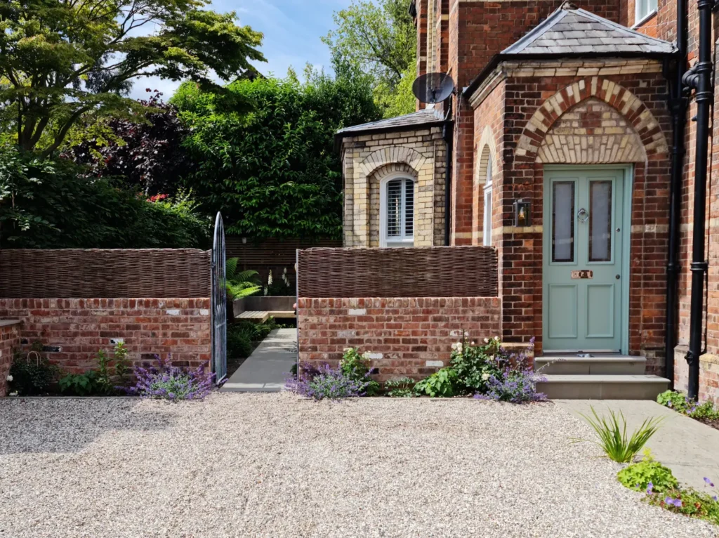 Victorian property front garden in Altrincham with gravel driveway and brick boundary wall
