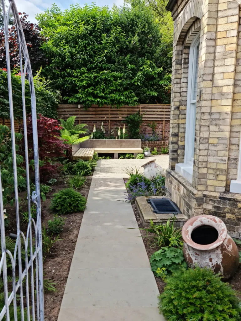 Sandstone path leading through planted Victorian garden remodel in Altrincham