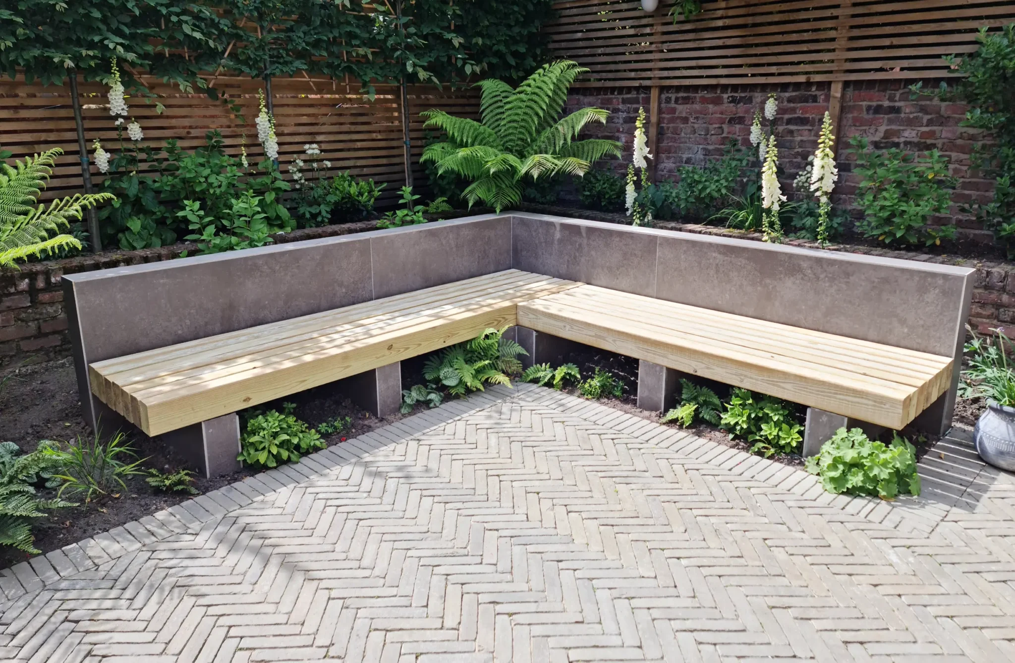 Built-in timber bench and herringbone clay paver patio in Altrincham garden remodel