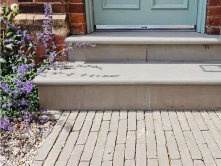 Sandstone entrance steps with clay paver path and cottage-style planting