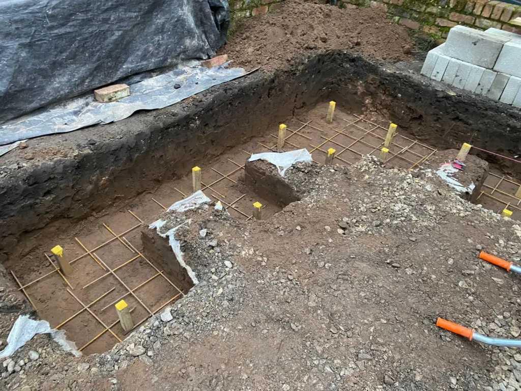 Concrete foundation preparation with reinforcing mesh for floating garden bench