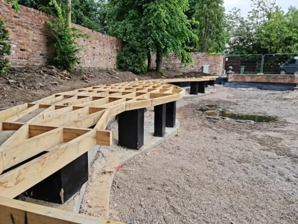 Sustainable oak deck subframe built on concrete pillars during Wilmslow pool renovation