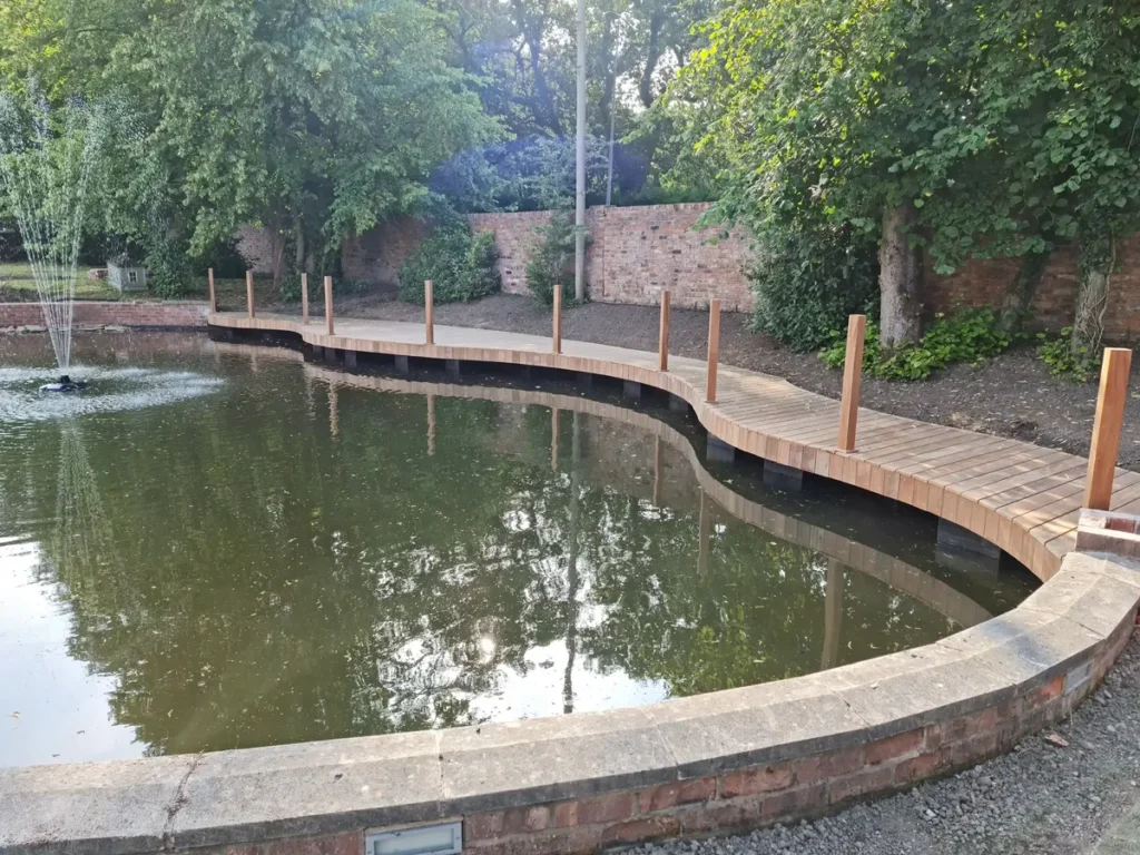 Timber deck installed around renovated pool with posts ready for handrail fitting