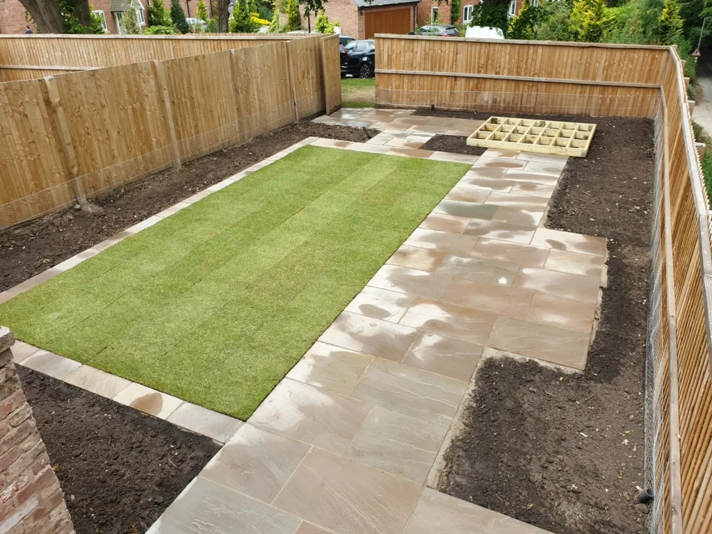 Newly laid lawn and sandstone paving during Malpas courtyard garden construction