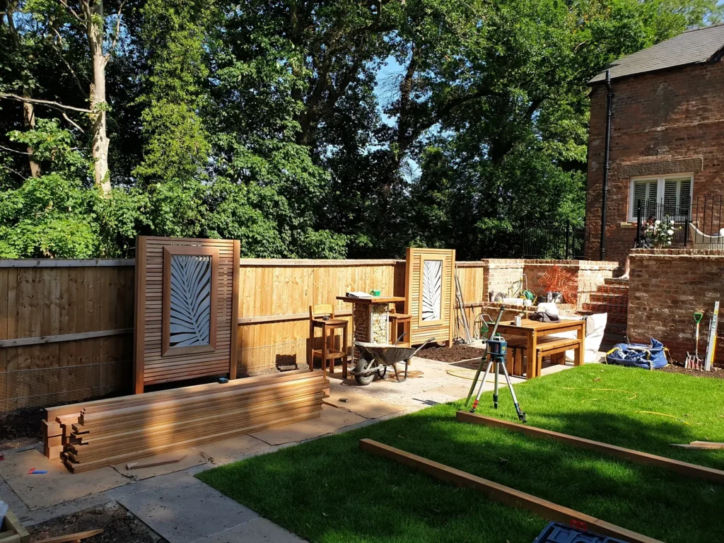 Red cedar feature screens and timber materials during courtyard garden landscaping in Malpas