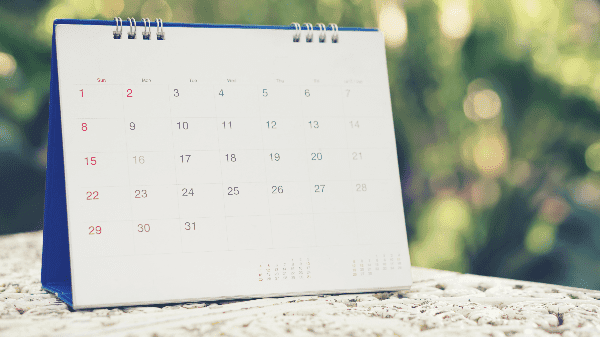 A spiral-bound calendar with a focus on the dates and layout.
